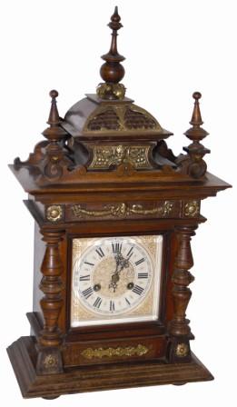 Junghans fancy mantle clock, several pieces of brass ornaments, and a 24" high walnut case that needs some stain/finish, and a few worm holes filled, primarily on the bottom board. — Antique Clocks Price Guide