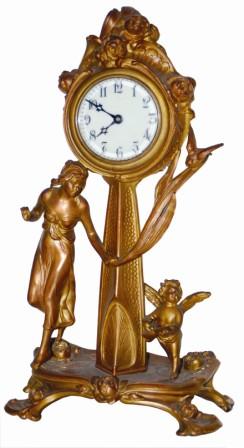 Large metal novelty clock standing 15.5" high, featuring a lady, cupid, and a bird. — Antique Clocks Price Guide
