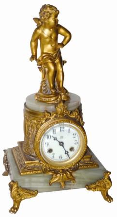 Jennings Bros marble statue clock with bronze/brass cupid on top. The metal ornaments and case body other than the marble, is brass. — Antique Clocks Price Guide
