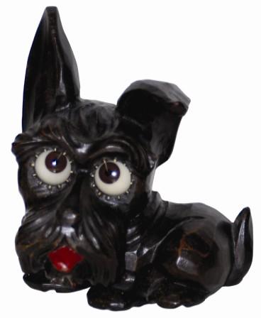 German Oswald Scottie Dog, made of molded composition, ca 1955. Six inch high case is signed and there is a label underneath. — Antique Clocks Price Guide
