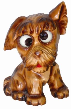 German, Oswald-Uhrenfabrik, carved composition floppy eared dog, ca 1948. This case is 6.5" high, made with a light colored material. — Antique Clocks Price Guide