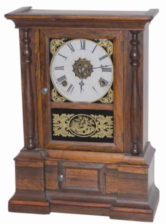 Atkins Clock Company, their common ca 1863 "London" model. Rosewood veneered case is 16.5" high, has plain half columns, and gold foil tablets. — Antique Clocks Price Guide
