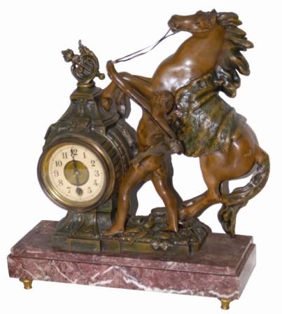 French statuary/clock with a good looking statue, and the clock tower does not look all that bad. The movement is a 30 hour balance, time only, and signed, "English Time Corp. — Antique Clocks Price Guide