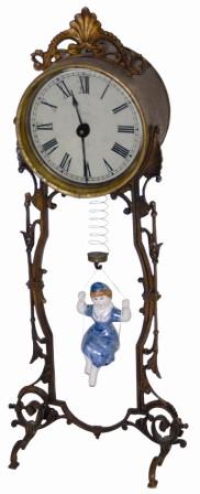 Bobbing Doll Clock, metal case is 14.5" high. — Antique Clocks Price Guide