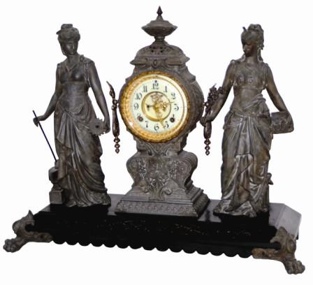 Ansonia Clock Company's large figure clock, a double statue, "Art And Commerce", ca 1894. The base is black enamel on iron with gold incised designs. — Antique Clocks Price Guide
