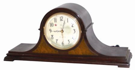 Telechron Motored / Westminster Chime, painted on the dial of this tambour clock. Complete label on the metal back cover that says in part, "Revere Chime / Telechron Motored / The Revere Clock Co. Cincinnati, Ohio". — Antique Clocks Price Guide