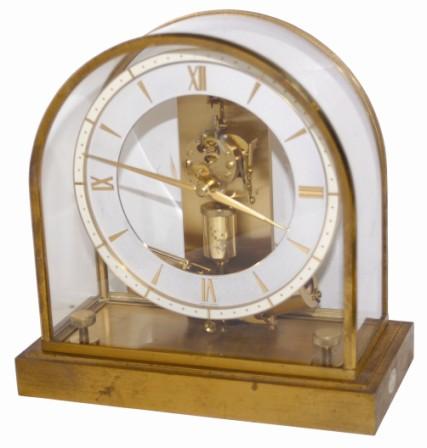 Junghans electric/battery clock, brass case, dome, and movement, battery underneath the base. The battery is signed, "Vigor / CM-Mis/871 / Clock Battery / Size 8,9 1.5 Volts". — Antique Clocks Price Guide