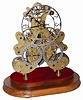Three dial skeleton clock with a double fusee movement. The large time dial is at the top, dial at bottom left shows weeks of the year, and dial at the bottom right shows the day of the month.