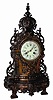 French metal clock, large and has many ornate pieces of castings. The finish is a strange color, black and copper tints.