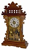 E. N. Welch Clock Co. walnut parlor clock, with an always poplar glass featuring the Roman army and their variety of weapons scattered all around the glass.