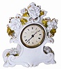 French white porcelain clock with delicate white flowers and some gold highlights. The porcelain petals are very thin and brittle, and for the most part has survived intact.