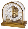 Junghans electric/battery clock, brass case, dome, and movement, battery underneath the base. The battery is signed, "Vigor / CM-Mis/871 / Clock Battery / Size 8,9 1.5 Volts".