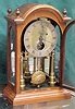 Bracket clock in oak with 3 glass mirror backed case.