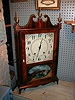 Pillar and scroll mantle clock with 30-hour wooden works.