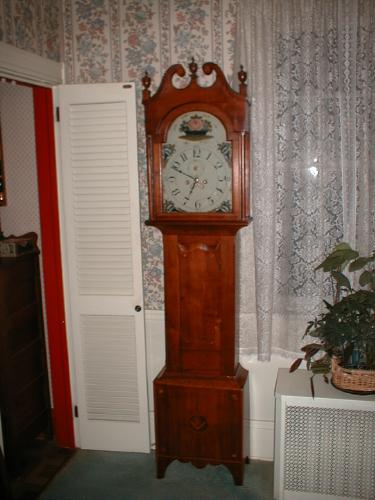 Smaller tall case clock with scrolled top and colorful dial. — Antique Clocks Price Guide