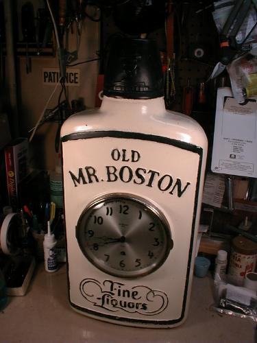 Replica of OLD MR BOSTON whiskey bottle with 8-day clock by Gilbert Clock Co. — Antique Clocks Price Guide