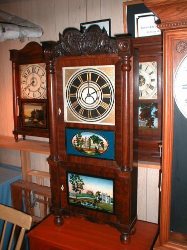Triple decker mantle clock with reverse-painted tablets and eight-day strap movement. — Antique Clocks Price Guide