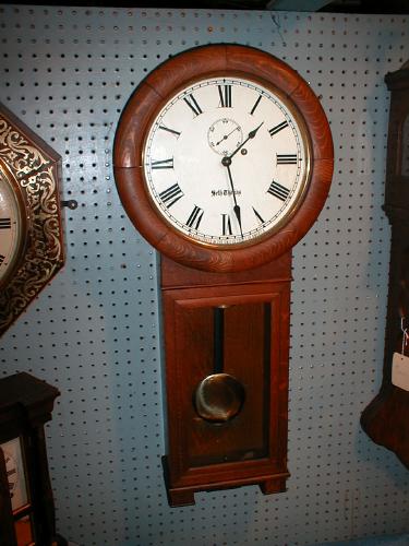 Round top, solid Oak weight-powered wall clock. — Antique Clocks Price Guide