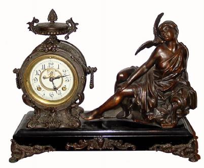 C.1913 New Haven Clock Co., ÓLa CaresseÒ, 8-day time/strike spelter figural mantel clock, seated female figure, caressing a dove at her cheek. — Antique Clocks Price Guide