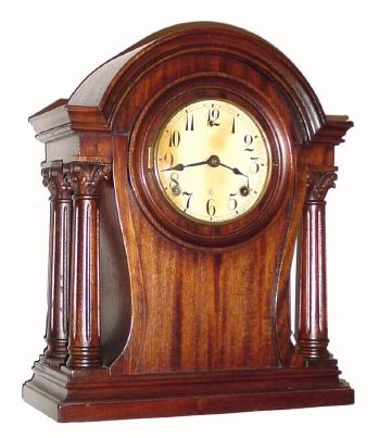 C.1920, William L. Gilbert Clock Co., 8-day time/strike mahogany mantel clock. We couldnÕt find this particular model in the Gilbert catalog, but it is very good looking with 4 Corinthian columns, arched top and shaped sides. — Antique Clocks Price Guide