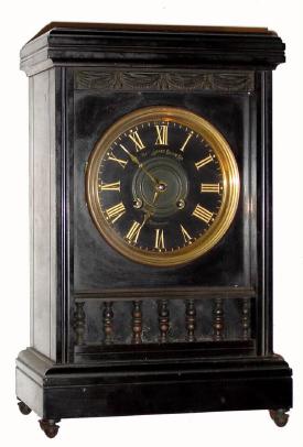 C.1890, New Haven Clock Co., 8-day time/strike French black marble and bronze mantel clock that was imported by New Haven and marketed by them. Note bronze balusters below dial and cast swag above — Antique Clocks Price Guide