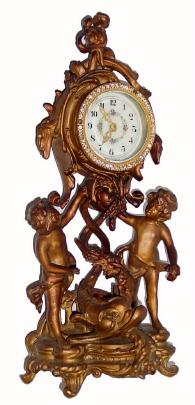 C.1910, New Haven Boudoir clock, 30-hour, gilded spelter with ÓbrilliantÒ sash and fancy porcelain dial. Note pleasant motif, with clock held aloft by 2 cherubs and a happy looking porpoise on the base. — Antique Clocks Price Guide