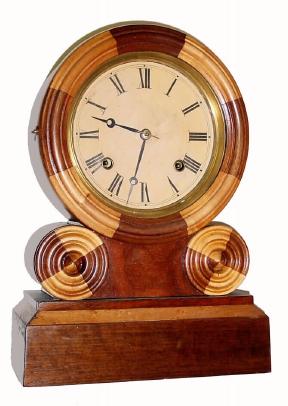 C.1885, E. Ingraham and Co., Bristol, mosaic shelf clock with wonderful alternating maple and walnut veneers, 8-day time and strike. — Antique Clocks Price Guide