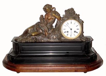 C.1870, French, Bronze and Marble Figural clock, ÒReclining HarvestÓ with a sickle in one hand and a sheaf of wheat in the other hand, 8-day time and strike. — Antique Clocks Price Guide