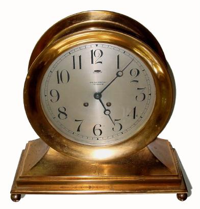 C.1920, Chelsea, 8.5Ó Dial, ShipÕs Bell on Base with ball feet, the dial engraved with the name of the retailer, ÒGrogan and Co., PittsburghÓ, hinged bezel with button latch. — Antique Clocks Price Guide