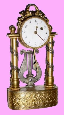C.1810, Austrian, Miniature 1-Day Timepiece, with tiny verge movement and porcelain dial. The portico style case with silvered leaves winding around the smooth gilt columns, and surmounted by a ribbon bow with acanthus wreath center. — Antique Clocks Price Guide