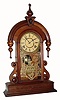 C.1881 Waterbury Clock Co., ÓParisÒ, 8-day time/strike walnut mantel clock. This looks to be a variation on this model as the lower sidepieces are of a slightly different design and the finial and drops are more robust. 