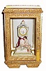 C.1900, French, Mini Figural Clock, a seated lady holding a shield with a Greek goddess embossed on the front surface, in a gilded modern case. 