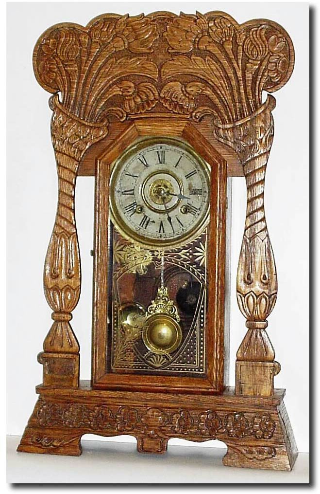 C.1905, New Haven Clock Co., "Norwich Linen" model pressed oak gingerbread in good condition. — Antique Clocks Price Guide