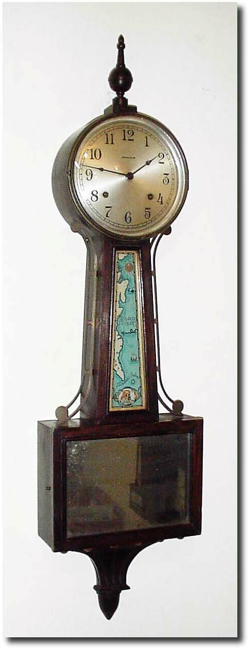 C.1935, E. Ingraham, "Treasure Island' Banjo, as-found, now with wooden top finial and mirror in lieu of pirate tablet in lower door (glass replacements are available from Karl Barathy). — Antique Clocks Price Guide