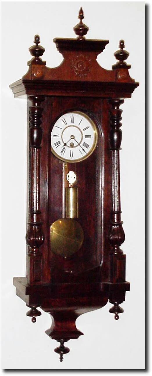 C.1890, German, a small 1-Weight wall regulator, with improper restorations. 1> the movement is not original to the case - two other sets of holes are present; 2> the dial is from a spring clock and has been married to the movement by drilling 3 large holes in the front plate; and 3> the top to the case is new, and case refinished. — Antique Clocks Price Guide
