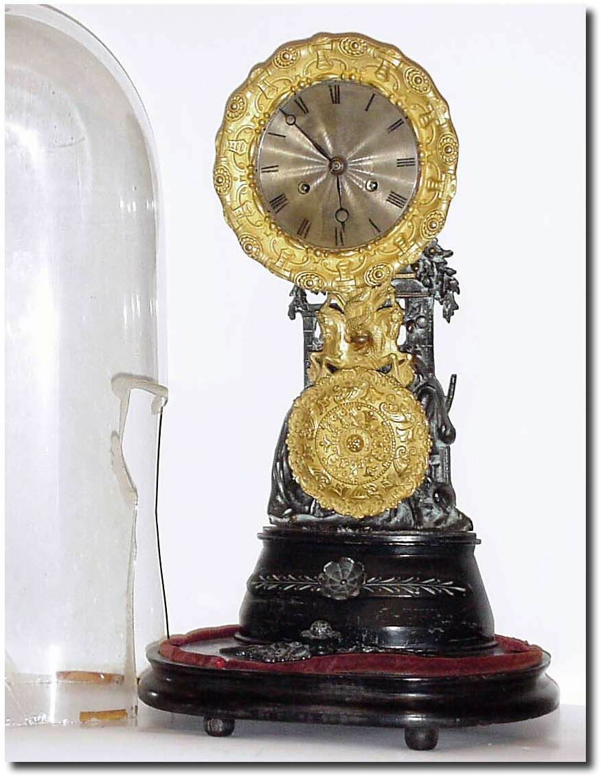 C.1890, Mixed lot: A good bell strike French movement, now mounted to a bronze memorial stand, from the same period, showing a woman with a man and his dog, the pendulum swinging in front of the couple. — Antique Clocks Price Guide