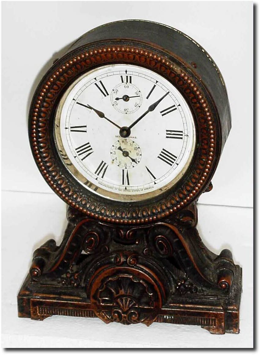 C.1910, Seth Thomas "Long Alarm', the top a pressed brass canister and the base of spelter with antique finish. — Antique Clocks Price Guide
