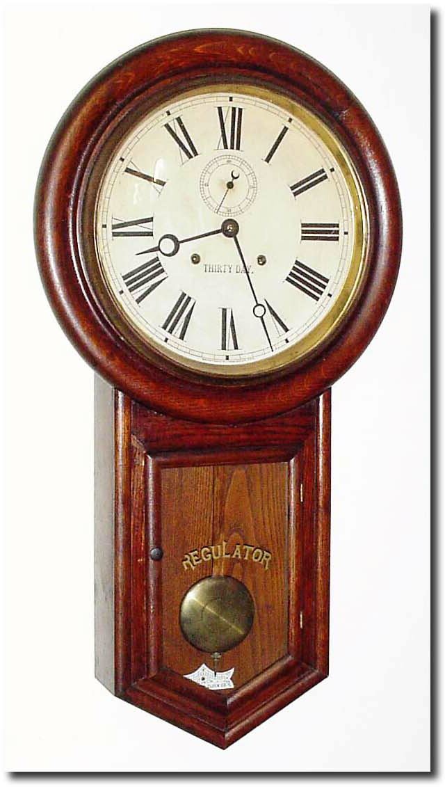 C.1910, Waterbury Clock Co., "Admiral', 30 Day Round drop in oak and in very good original condition, with original dial, finish, hands, beat scale and both rear labels (Model label illustrated). — Antique Clocks Price Guide