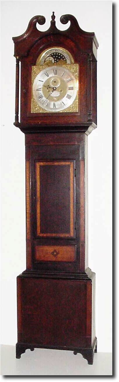 English, 1st Half 19th Century, a Midlands short door tall case, now with a good London make 8- day brass dial movement (C.1725) signed John Hill, King St., Covent Garden; the dial measures 13 x 17.5', and with an engraved brass rolling moon with silvered moon and stars; tidal indications above moon. — Antique Clocks Price Guide