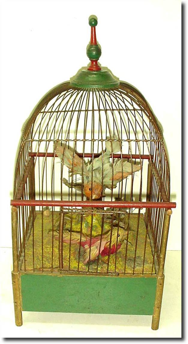 C.1950, German or Swiss, a novelty musical bird cage, with two animated birds that move with the bottom wind music box plays. — Antique Clocks Price Guide