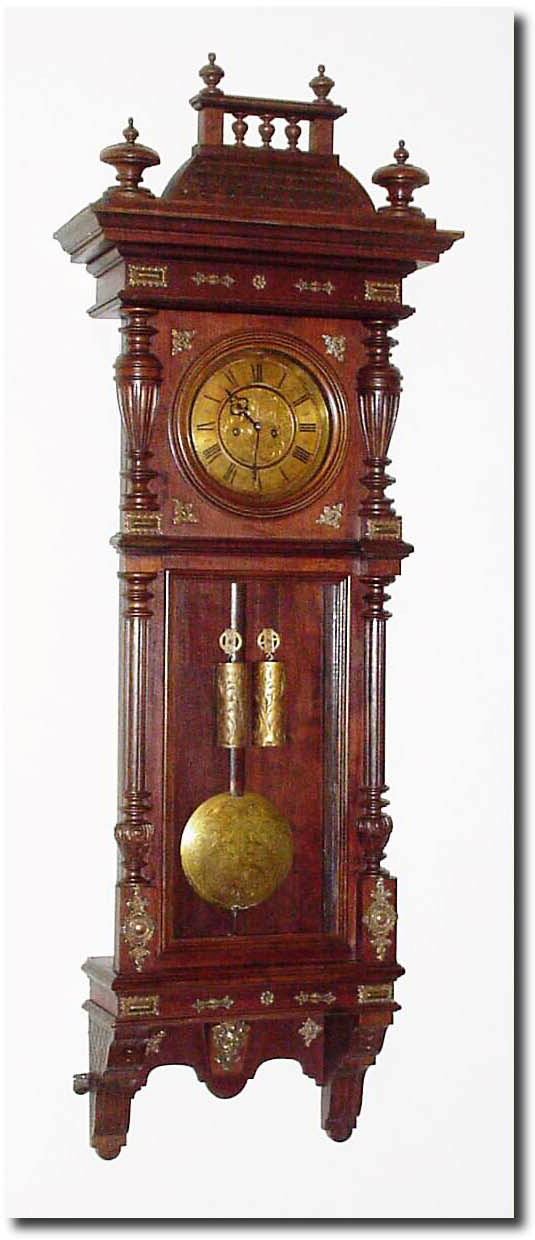 C.1890, Austrian, 2-weight "Vienna Regulator' in an Alt Deutsch walnut case with "roof' style top, and lots of brass trimmings on the front. — Antique Clocks Price Guide