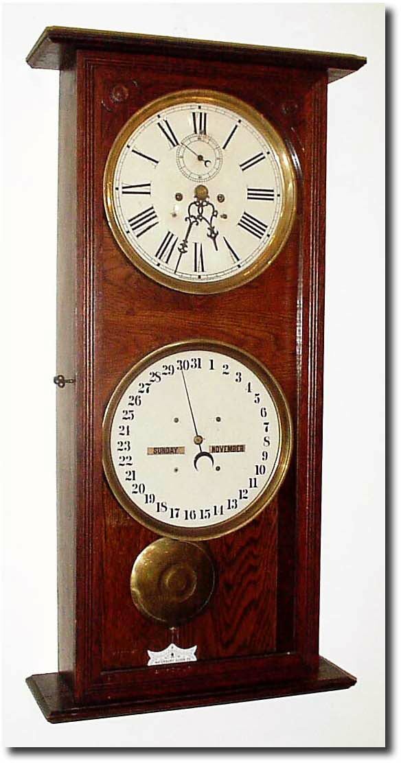 C.1910, Waterbury "Calendar No. 25' in oak, variant? This model as pictured in Waterbury"s literature is very fancy with trim pieces at both top and bottom of door, both front and back. — Antique Clocks Price Guide