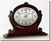 C.1925, Waltham Clock Co., 8-day Boudoir clock, the oval frame bearing the clock suspended in a yoke with turn screws on either side.
