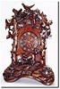 C.1900, German, Black Forest Shelf Cuckoo in well carved case showing a fox caught in a trap in the woods, surrounded by oak branches, oak leaves and acorns, and a cuckoo bird at the apex.