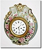 C.1880, French, a Porcelain Cartel Clock with pink and white roses, the art work signed by "M.G.', now with a C.1840 French silk thread time and strike movement with dial (fits well).