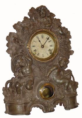 C.1860, Waterbury Clock Co., 8-day time/strike iron front mantel clock. "Children play in the grape vines" case marked 49 was made by N. Muller, NY (signed with name in the casting, patent 1856). — Antique Clocks Price Guide
