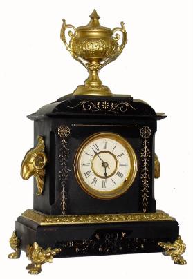 C.1880, Ansonia Clock Co., 8-day time/strike enameled iron cased mantel clock, with ram's heads on either side and a finial at the top. — Antique Clocks Price Guide