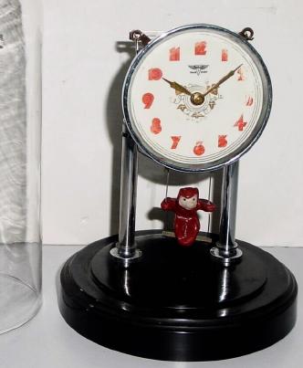 C.1950, Japan, Swinging Doll clock, 30 hour, under replacement dome. — Antique Clocks Price Guide