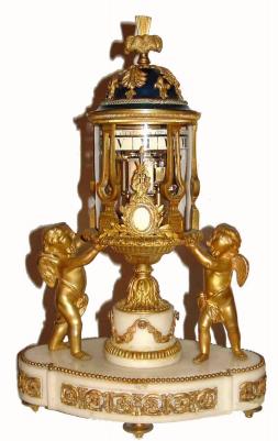 C.1875, French, Ormolu and White Marble Temple motif clock with revolving annular dials, the bell striking movement with platform lever escapement, driving both minute and hour rings, each with cartouche numerals, and in excellent original condition. — Antique Clocks Price Guide