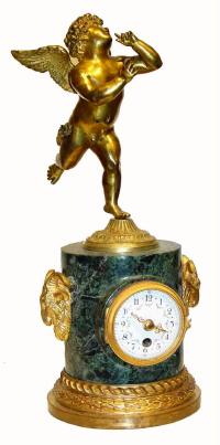 C.1880, French, Ormolu and Bronze figural clock, a variegated dark green marble base, surmounted by a winged male cherub, running with abandon. — Antique Clocks Price Guide